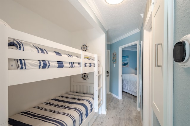 6300 Seawall Blvd Unit 9108, Galveston, TX 77551 - bedroom featuring wood finished floors, ornamental molding, baseboards, and a textured ceiling