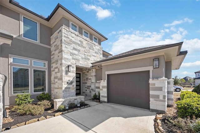 view of front of home with a garage, stone siding, concrete driveway, and stucco siding