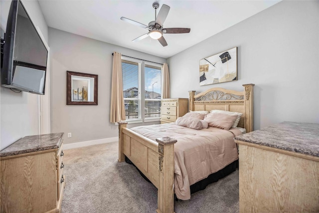 bedroom featuring light carpet, ceiling fan, and baseboards