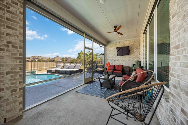 sunroom featuring a ceiling fan