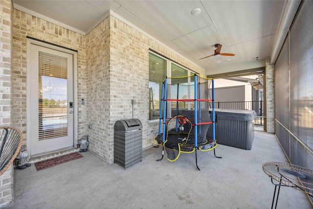 view of patio featuring a trampoline and a ceiling fan