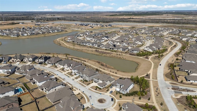 drone / aerial view featuring a residential view and a water view