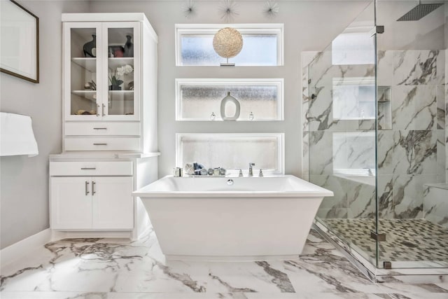 full bath featuring marble finish floor, a marble finish shower, and a freestanding bath