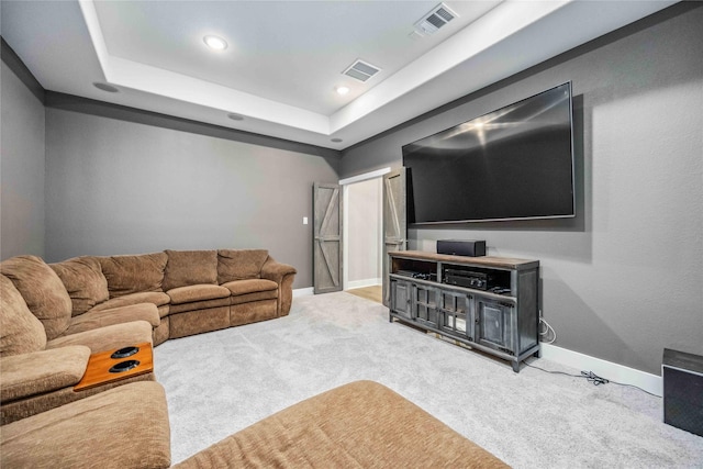 living area with carpet floors, a raised ceiling, visible vents, and baseboards