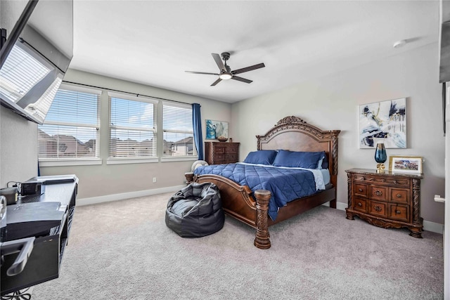 carpeted bedroom featuring baseboards and a ceiling fan