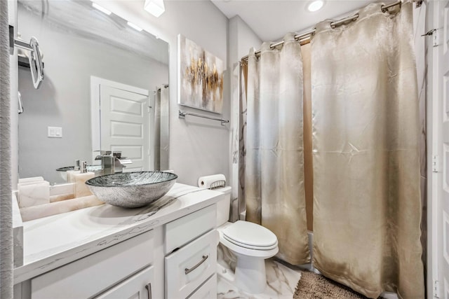 full bathroom with marble finish floor, shower / bath combo, vanity, and toilet