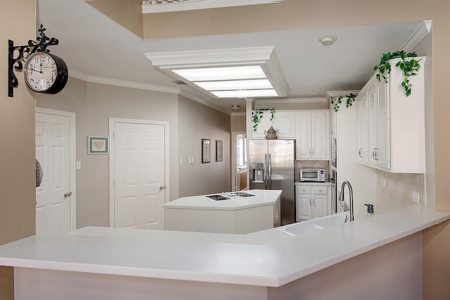 kitchen with a kitchen island, ornamental molding, a sink, stainless steel appliances, and backsplash