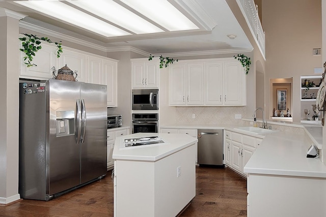 kitchen featuring appliances with stainless steel finishes, white cabinetry, a sink, and dark wood-style floors