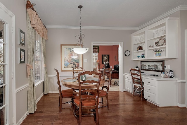 dining room featuring dark wood-style floors, crown molding, and a healthy amount of sunlight