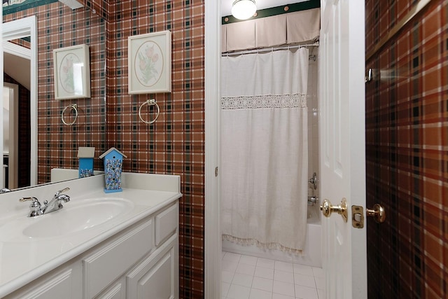 full bathroom with tile patterned flooring, tile walls, vanity, and shower / tub combo