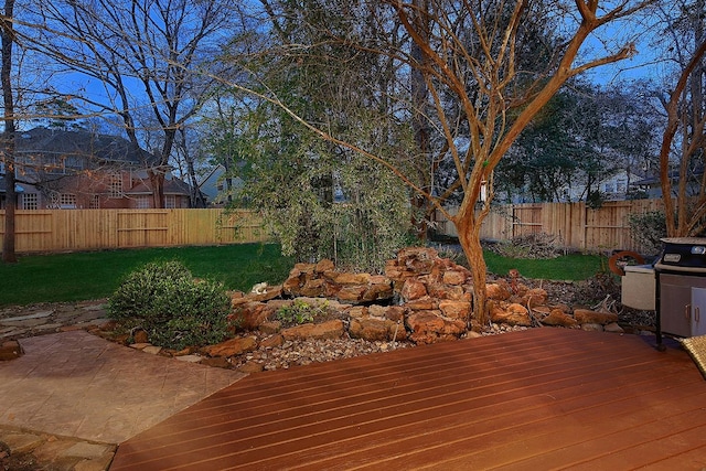 deck featuring a fenced backyard and a patio