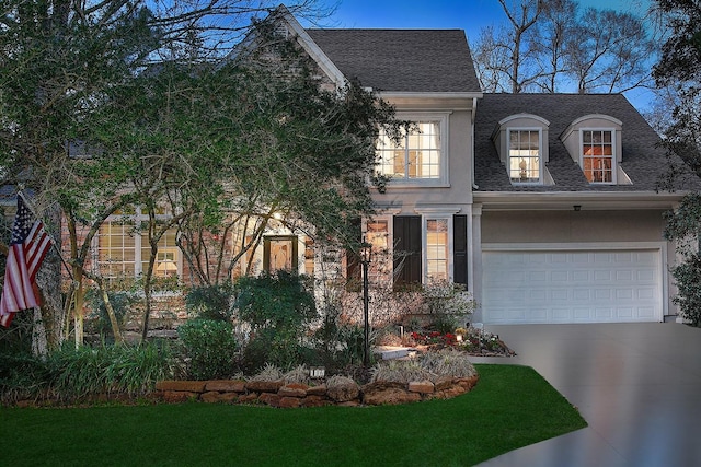 view of front of home featuring a shingled roof, driveway, an attached garage, and stucco siding