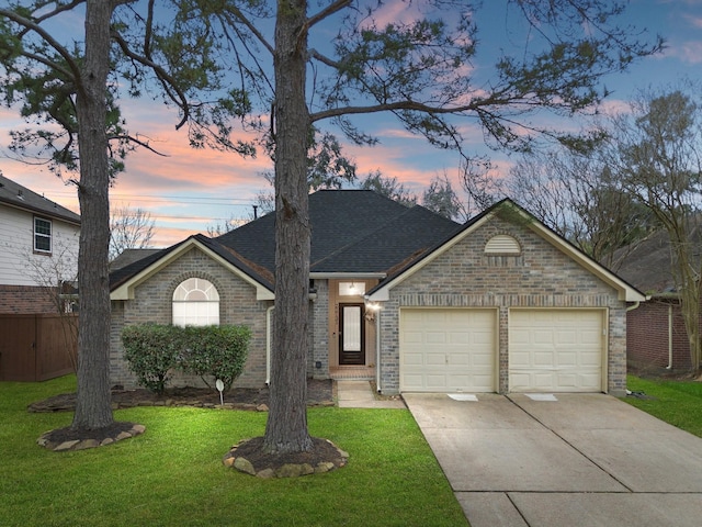 view of front of home with a garage, driveway, brick siding, and a front yard