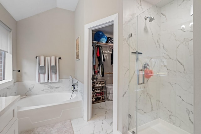 full bathroom featuring marble finish floor, a spacious closet, vaulted ceiling, and a marble finish shower