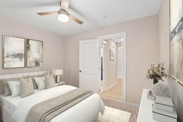 bedroom featuring ceiling fan, baseboards, and light colored carpet