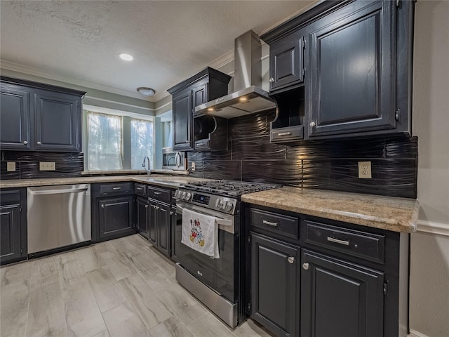 kitchen with stainless steel appliances, tasteful backsplash, dark cabinetry, and extractor fan