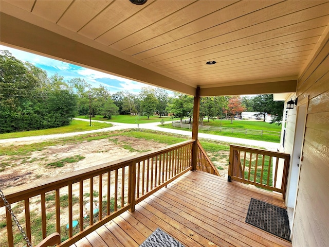 wooden terrace with a lawn