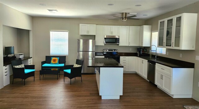 kitchen featuring a sink, dark wood finished floors, appliances with stainless steel finishes, and a healthy amount of sunlight