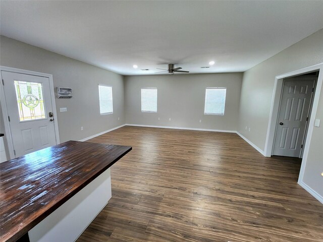 interior space featuring recessed lighting, baseboards, ceiling fan, and dark wood-style floors