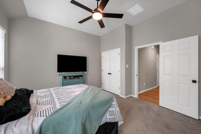 unfurnished bedroom featuring visible vents, baseboards, vaulted ceiling, a closet, and carpet