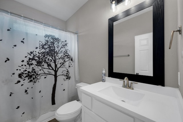 full bath with curtained shower, vanity, and toilet