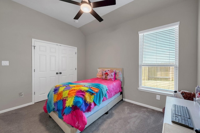 carpeted bedroom featuring vaulted ceiling, a closet, a ceiling fan, and baseboards