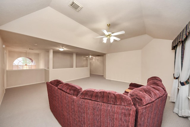 carpeted living room with vaulted ceiling, baseboards, visible vents, and a ceiling fan