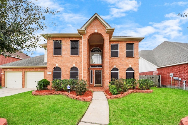 view of front of house featuring a front yard, brick siding, driveway, and an attached garage