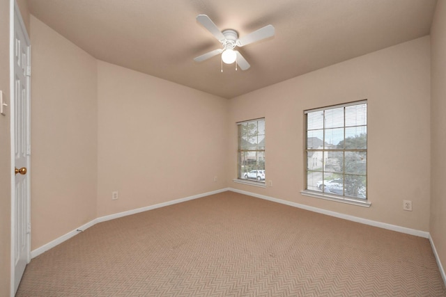 empty room with ceiling fan, carpet flooring, and baseboards