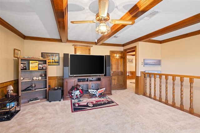 8011 Beaufort Dr, Spring, TX 77379 - carpeted living area featuring a wainscoted wall, beam ceiling, ornamental molding, and visible vents