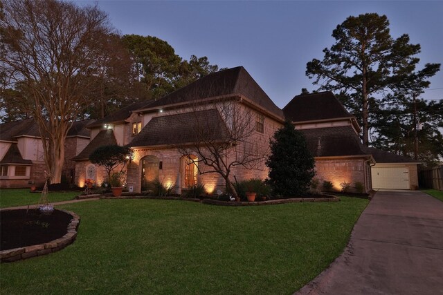 8011 Beaufort Dr, Spring, TX 77379 - view of front of house featuring a front yard, brick siding, and a detached garage