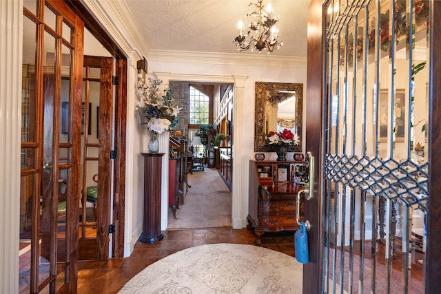 8011 Beaufort Dr, Spring, TX 77379 - entryway with a chandelier, crown molding, and a textured ceiling