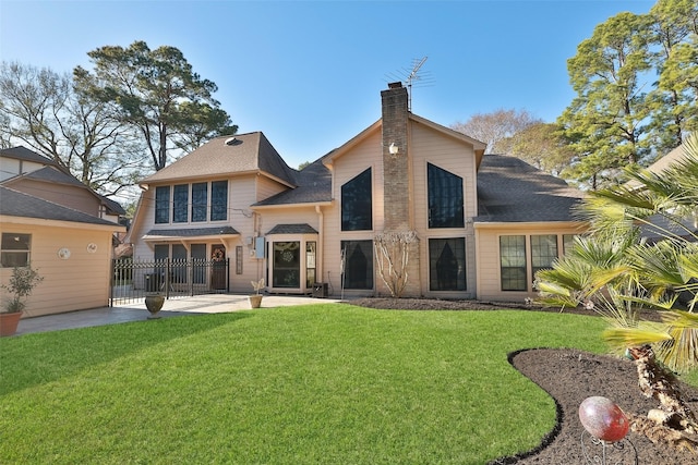 8011 Beaufort Dr, Spring, TX 77379 - back of property with a shingled roof, a chimney, fence, and a yard