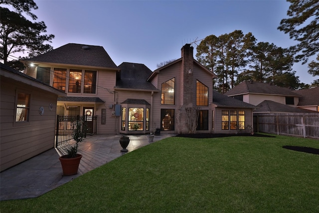 8011 Beaufort Dr, Spring, TX 77379 - rear view of property with a yard, a patio area, fence, and a chimney