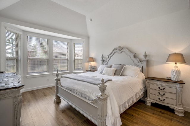 bedroom featuring dark wood-style floors and baseboards