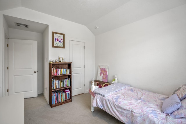 bedroom featuring lofted ceiling, visible vents, and carpet