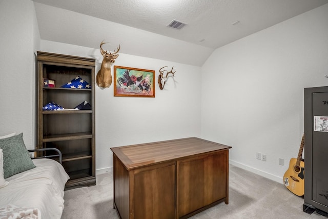 office area with light carpet, vaulted ceiling, visible vents, and baseboards