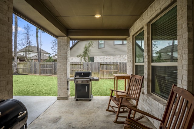 view of patio / terrace with a grill and fence