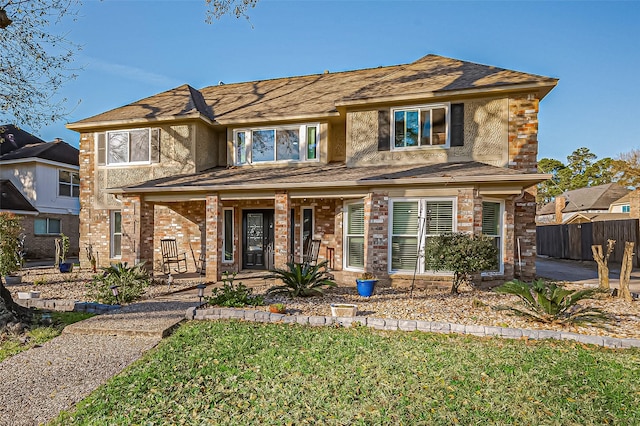 view of front of home featuring a porch, a front lawn, and fence