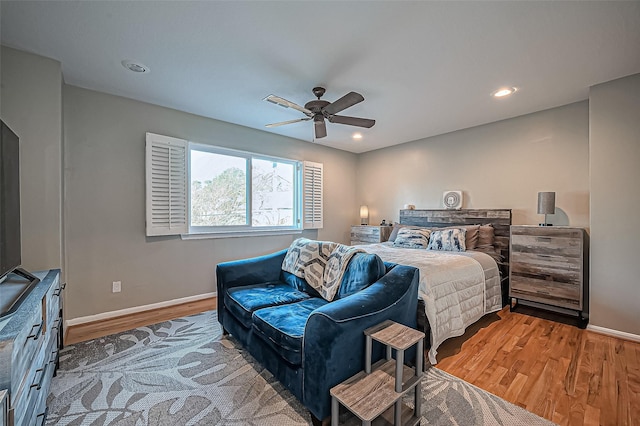 bedroom with a ceiling fan, baseboards, wood finished floors, and recessed lighting