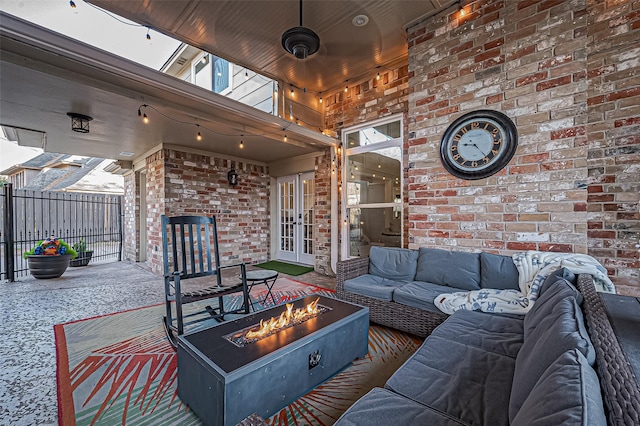 living room featuring brick wall, wooden ceiling, carpet flooring, and track lighting