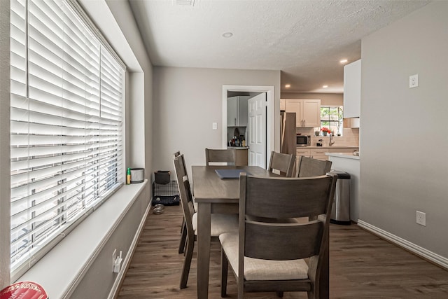 dining space with recessed lighting, dark wood-style floors, baseboards, and a textured ceiling