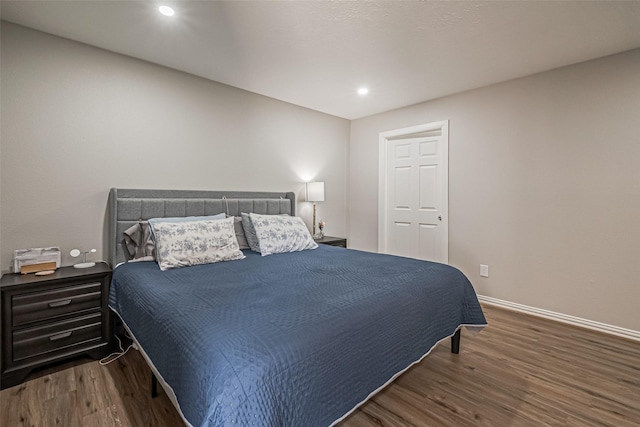 bedroom featuring recessed lighting, wood finished floors, and baseboards