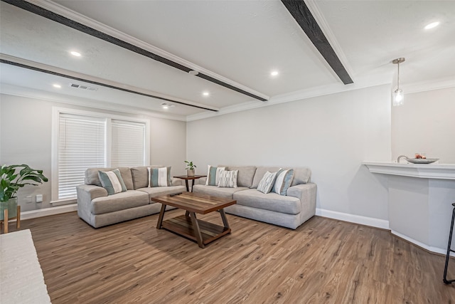 living room with crown molding, baseboards, beamed ceiling, recessed lighting, and wood finished floors