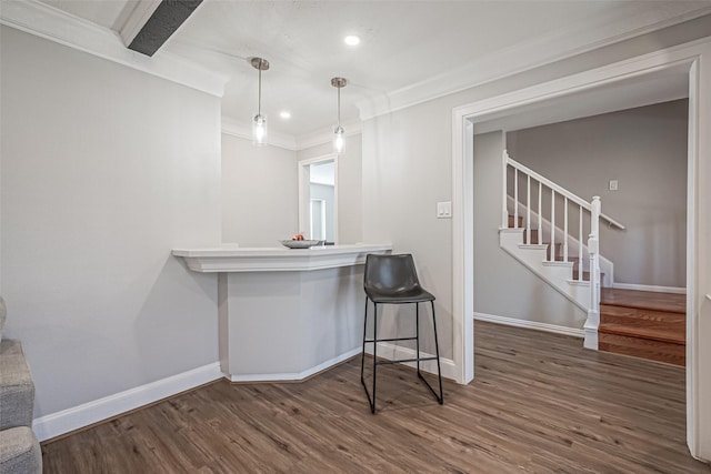 bar featuring stairs, wood finished floors, baseboards, and ornamental molding