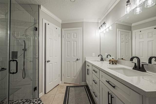 bathroom featuring a marble finish shower, ornamental molding, a textured ceiling, and a sink