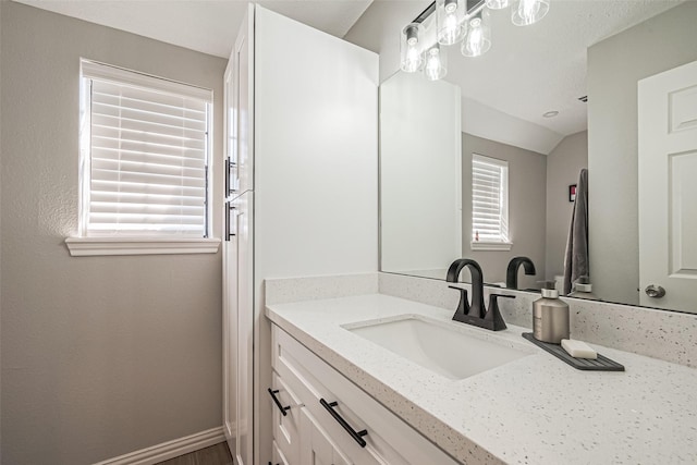 bathroom with vanity and baseboards