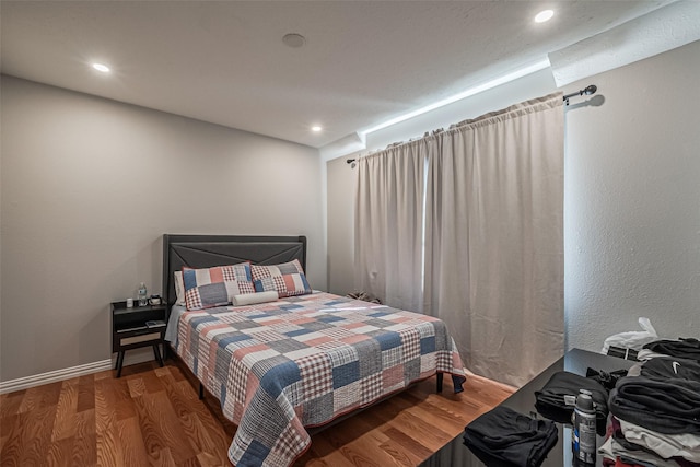 bedroom featuring recessed lighting, baseboards, and wood finished floors