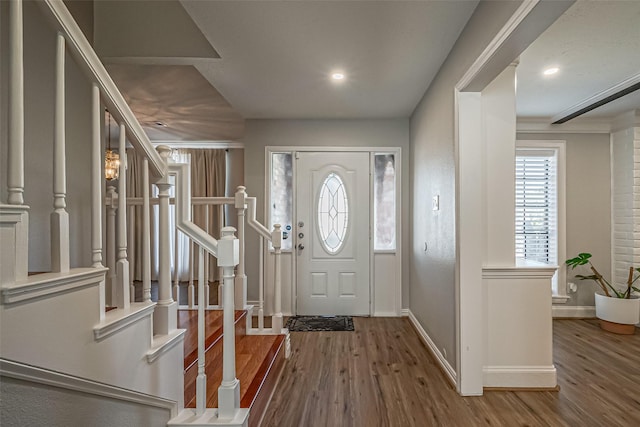 entrance foyer featuring stairway, baseboards, and wood finished floors