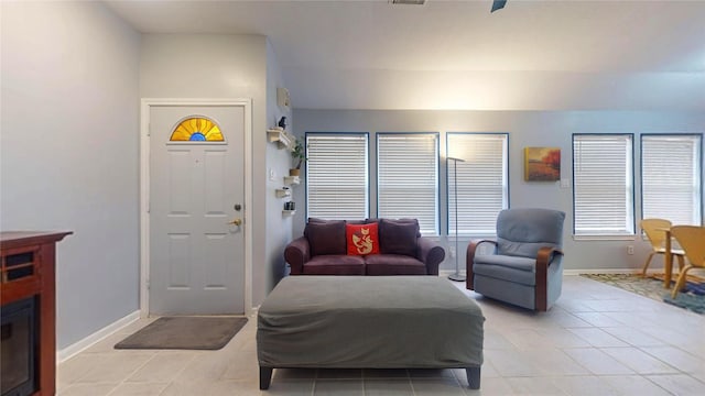 living area featuring light tile patterned floors and baseboards